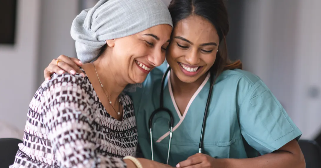 Two people sitting with one embracing the other Two people sitting with one embracing the other