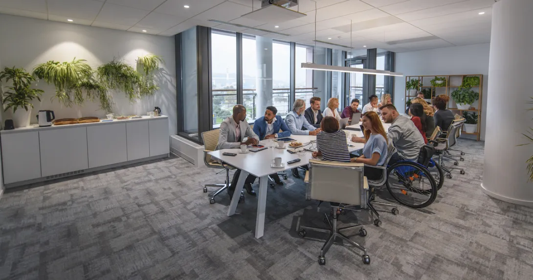People sitting around a table in a conference room People sitting around a table in a conference room