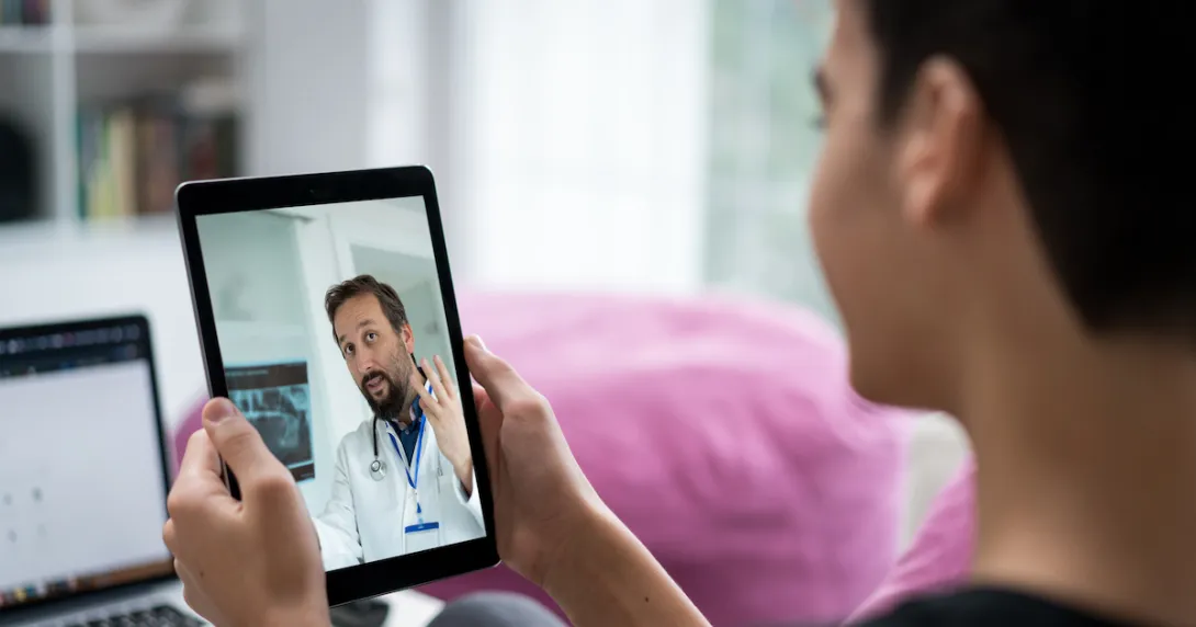 Person talking to a healthcare provider on a tablet