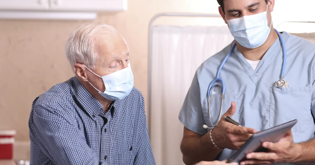 Healthcare provider and senior citizen on a tablet Healthcare provider and senior citizen on a tablet