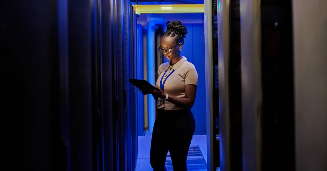 Person standing in a data center Person standing in a data center