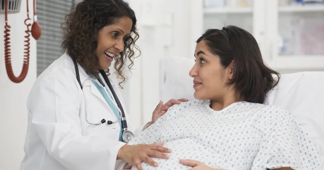 Healthcare provider evaluating a pregnant person Healthcare provider evaluating a pregnant person