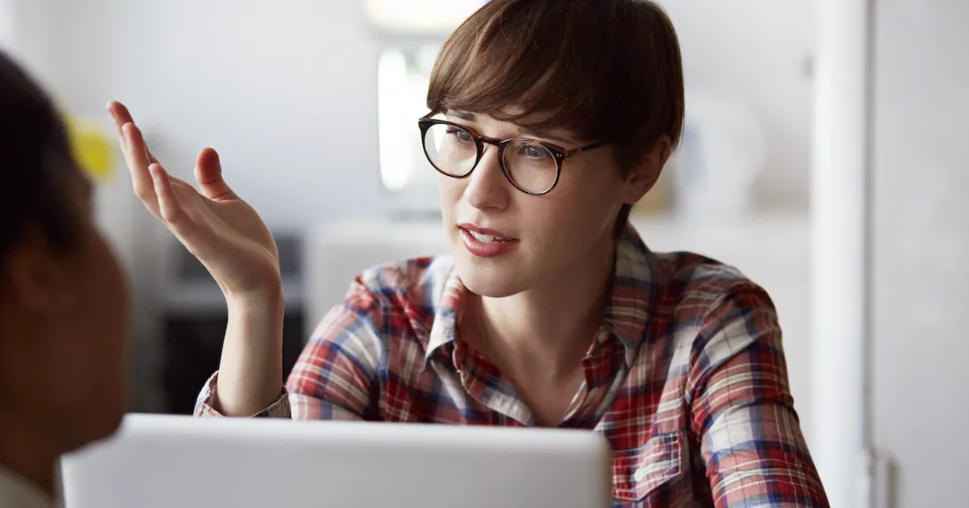 Person at a computer talking Person at a computer talking