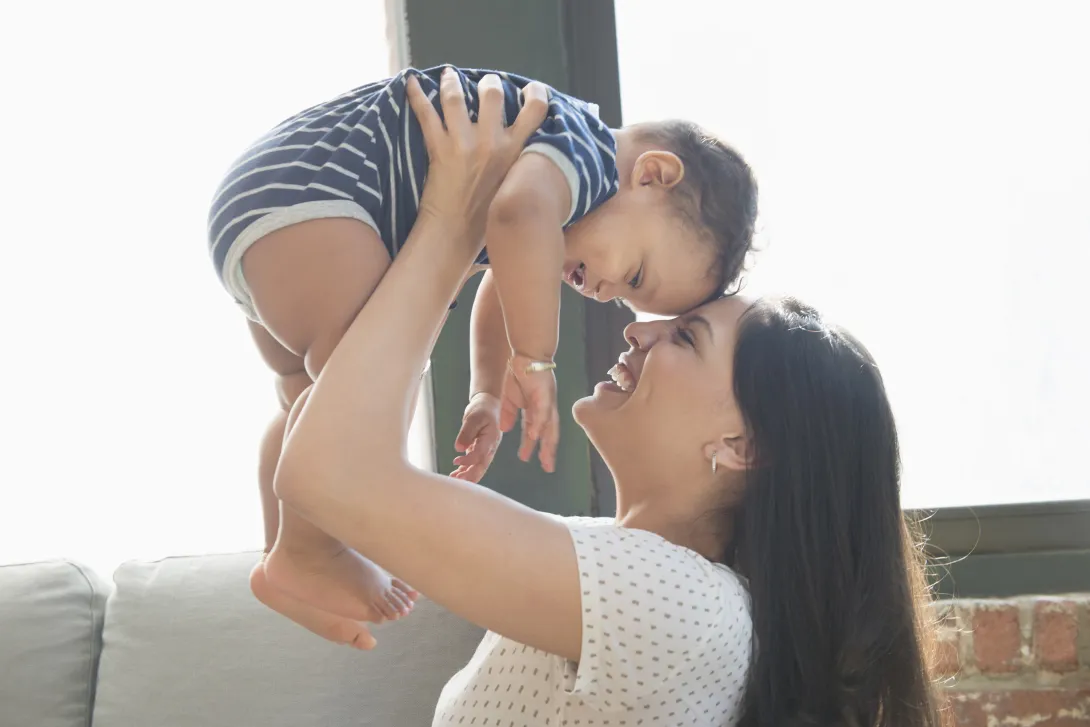 Young woman holding baby A young woman holding a baby.