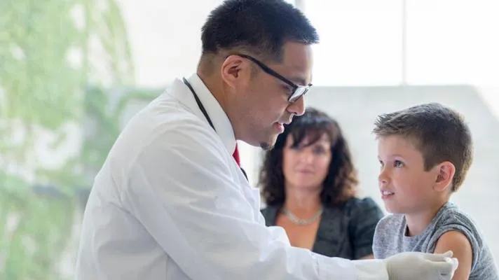 Doctor giving injection to pediatric patient Doctor giving injection to pediatric patient