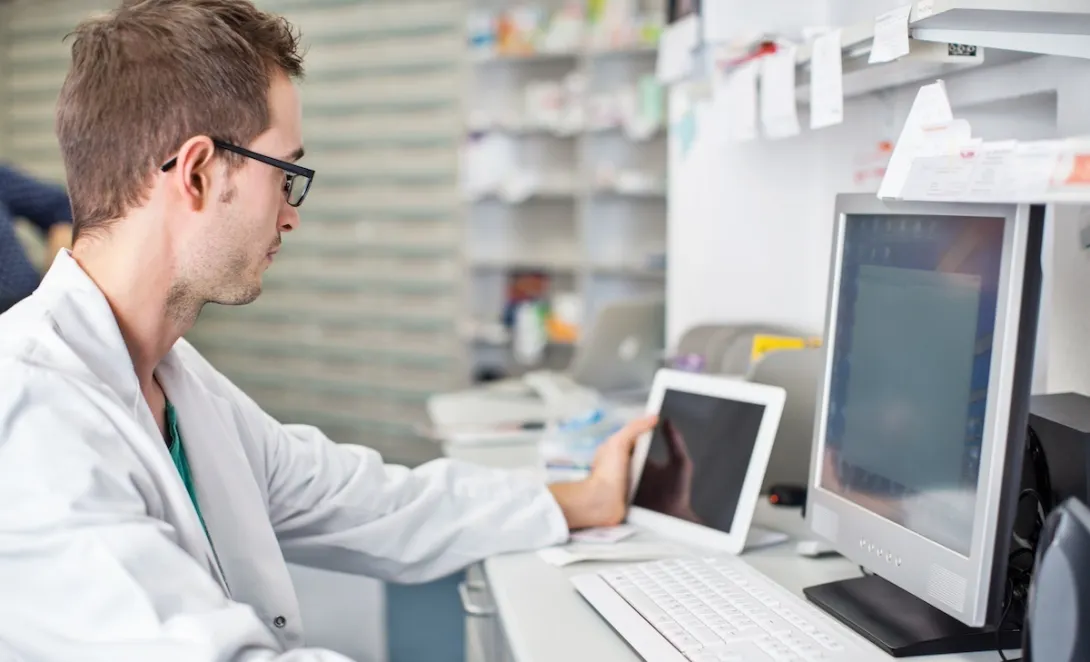Clinician looking at data on a smart pad tablet and computer screen Clinician looking at data on a smart pad  tablet and computer screen