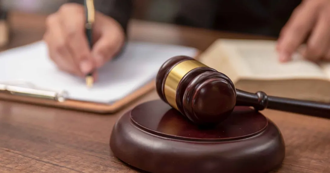 Judge signing a document in a courtroom Judge signing a document in a courtroom