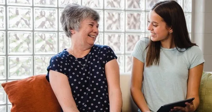 A woman using the LifeBio app with a caregiver A woman using the LifeBio app with a caregiver