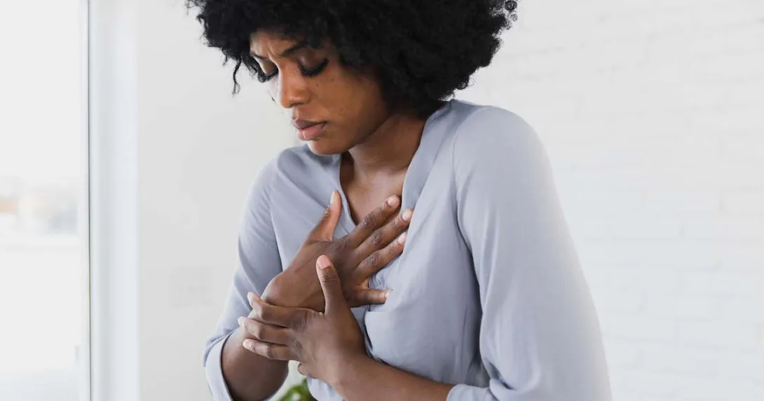 Person holding their chest Person holding their chest