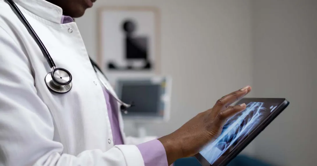 Healthcare provider looking at x-ray images on a tablet Healthcare provider looking at x-ray images on a tablet