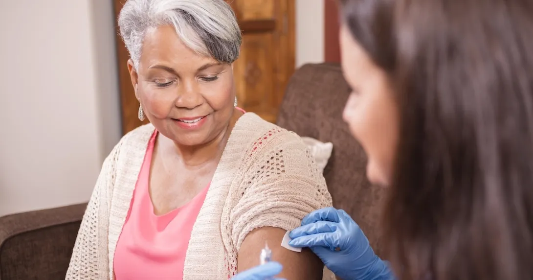 Health care professional administering an injectable medication Health care professional administering an injectable medication