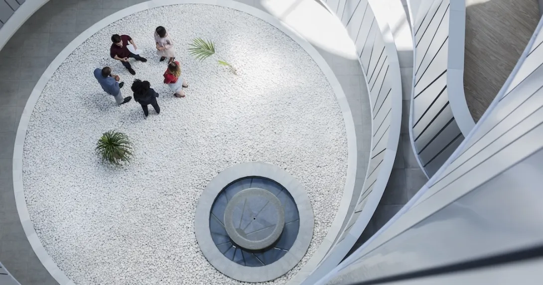 Employees gathering  in an atrium Employees gathering in an atrium
