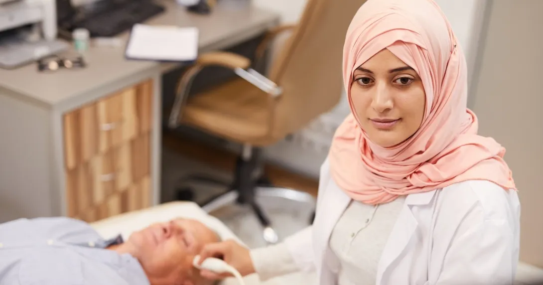 Technician performing ultrasound procedure Technician performing ultrasound procedure