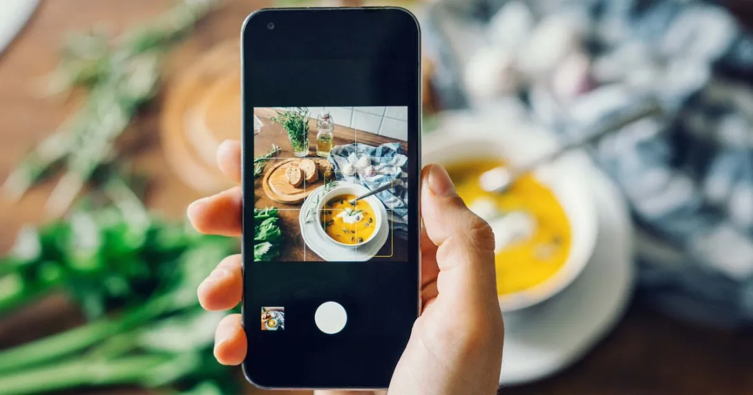 Person taking a photo of their meal with a smartphone Person taking a photo of their meal with a smartphone