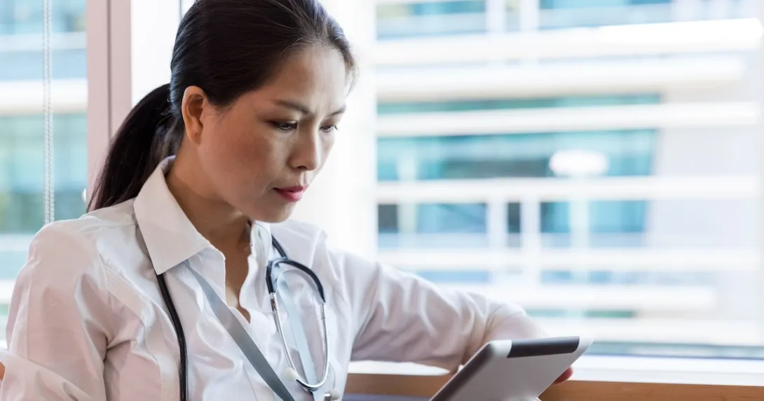 Healthcare practitioner reviewing EMR Healthcare practitioner reviewing EMR