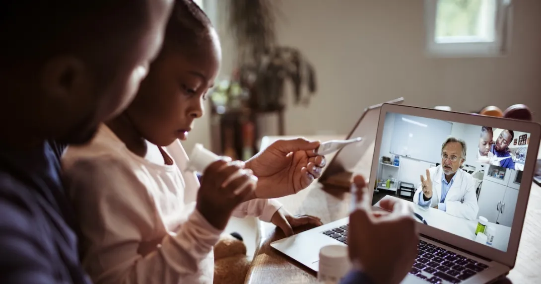 Two people conferring with a healthcare professional via a laptop computer Two people conferring with a healthcare professional via a laptop computer