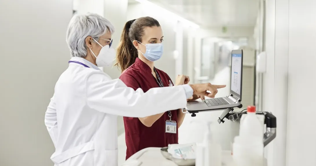 Clinicians reviewing data on a laptop Clinicians reviewing data on a laptop