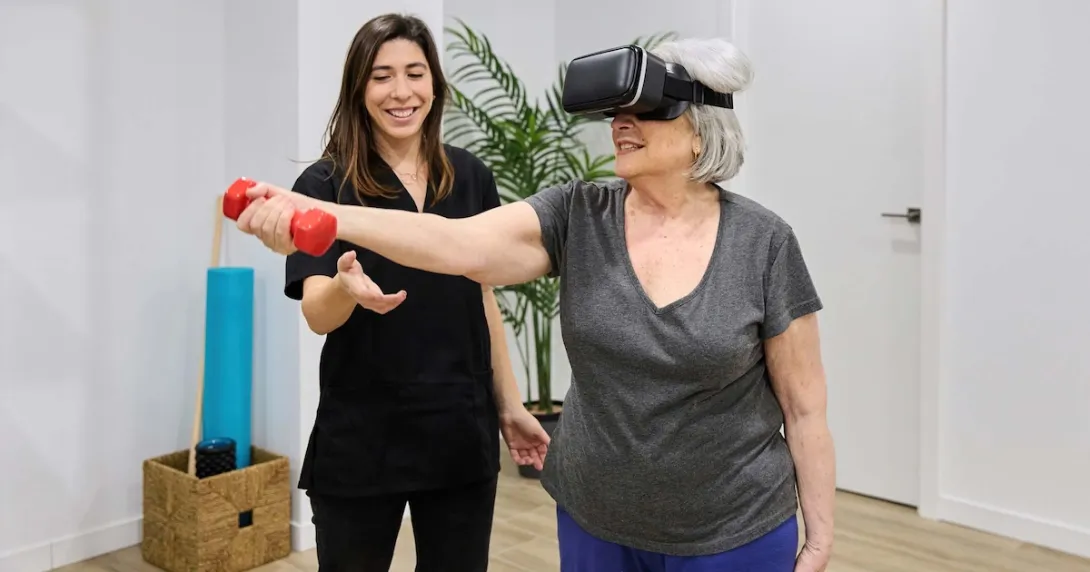 Person doing rehabilitation exercises while wearing a headset and standing next to a PT