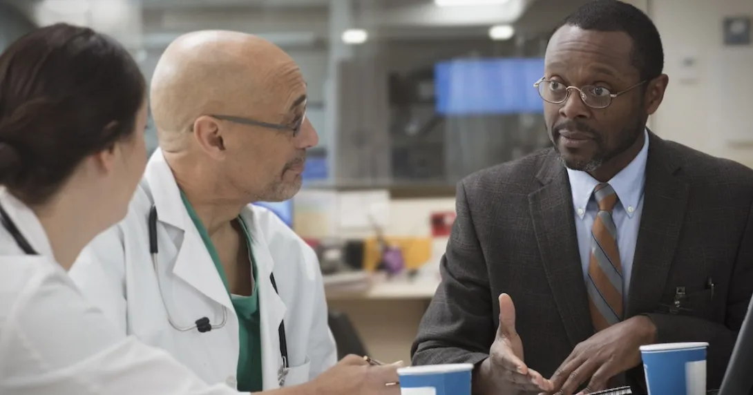 Clinicians in discussion with administrator Clinicians in discussion with administrator