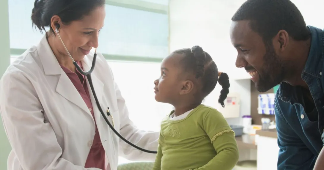 A parent with a toddler at a doctor's appointment A parent with a toddler at a doctor's appointment
