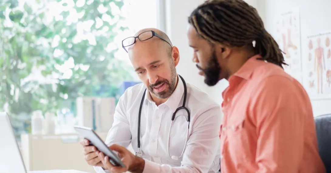 A man talking to his primary care provider A man talking to his primary care provider