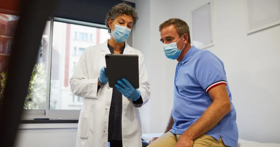 A medical professional showing a patient information on a tablet A medical professional showing a patient information on a tablet