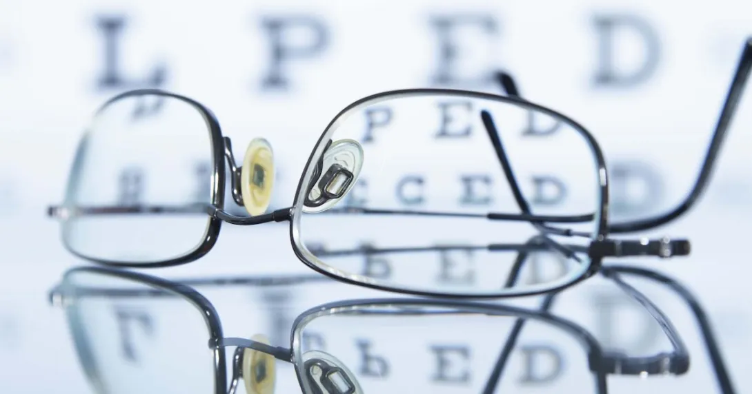 Glasses lying in front of an eye chart Glasses lying in front of an eye chart