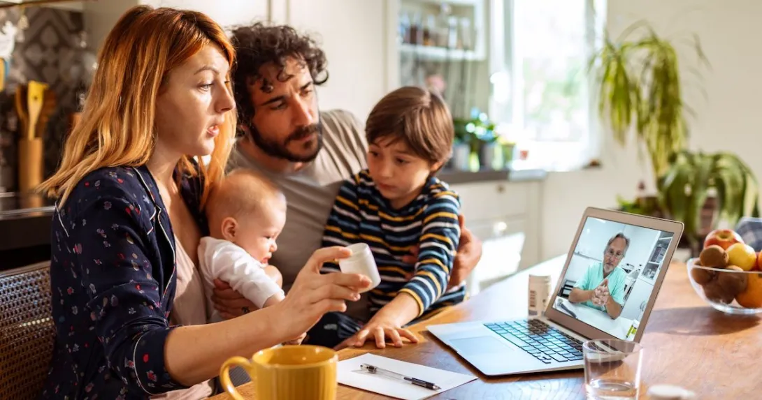 A family talking to a doctor on their laptop. A family talking to a doctor on their laptop.