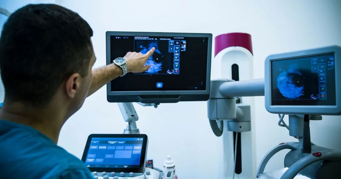A doctor looking at a mammogram. A doctor looking at a mammogram.
