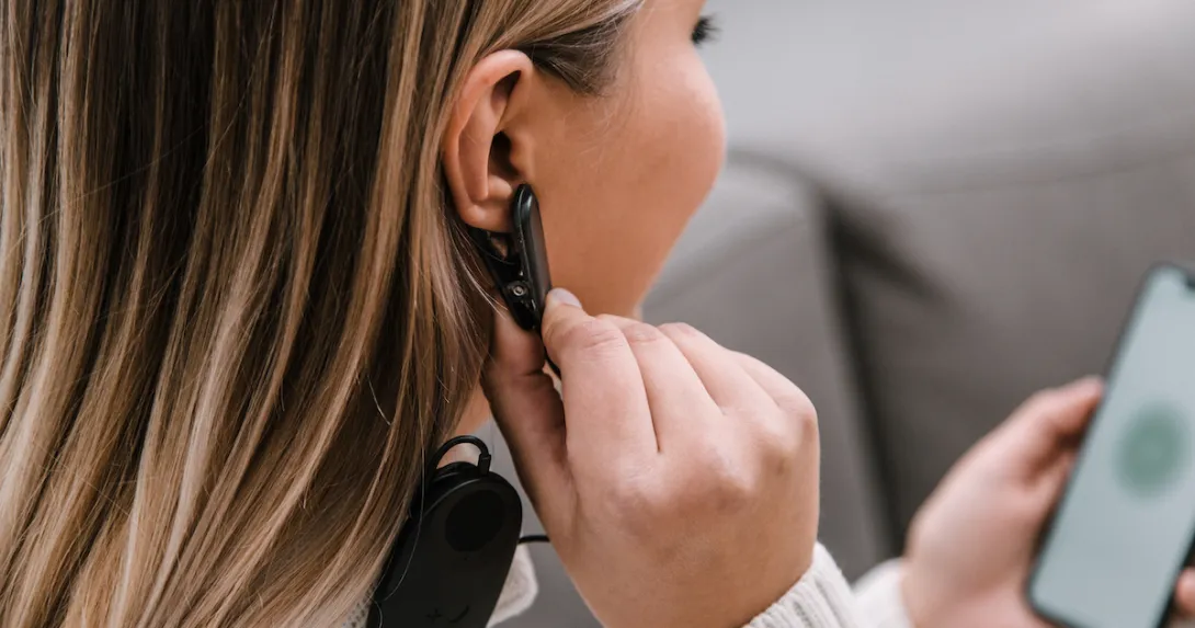 A close up of a woman using Meru's biofeedback device and app.