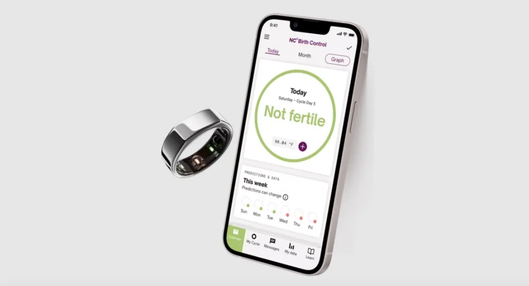 An image of a smartphone displaying the Natural Cycles app next to an Oura Ring. An image of a smartphone displaying the Natural Cycles app next to an Oura Ring.