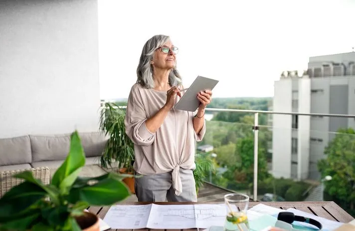 An older woman using a tablet. An older woman using a tablet.