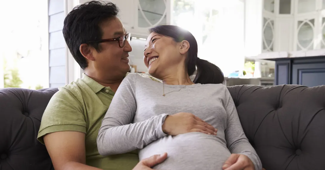 A pregnant woman and her partner A pregnant woman and her partner