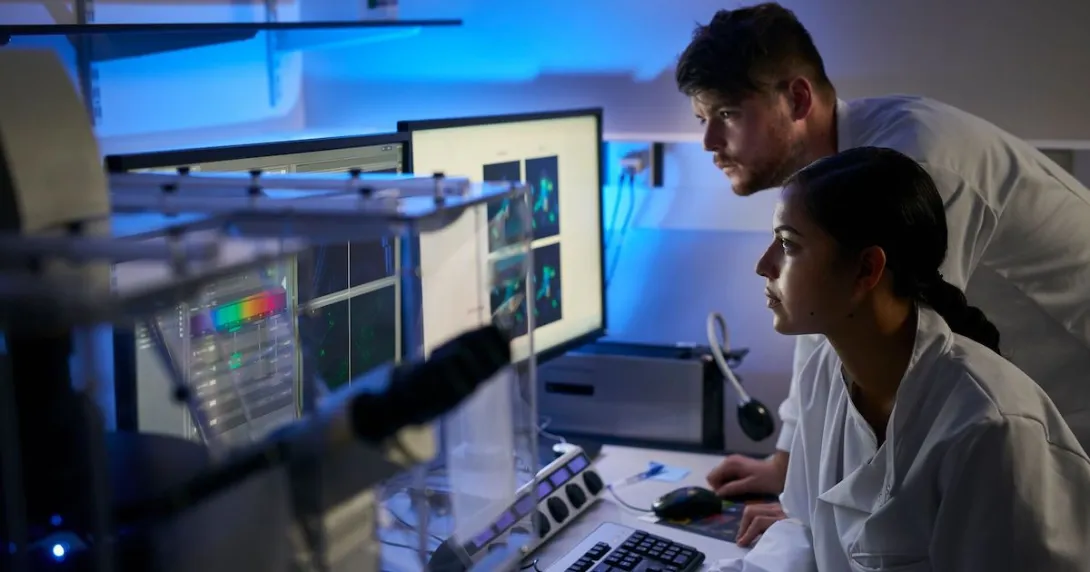Researchers looking at data on a computer Researchers looking at data on a computer