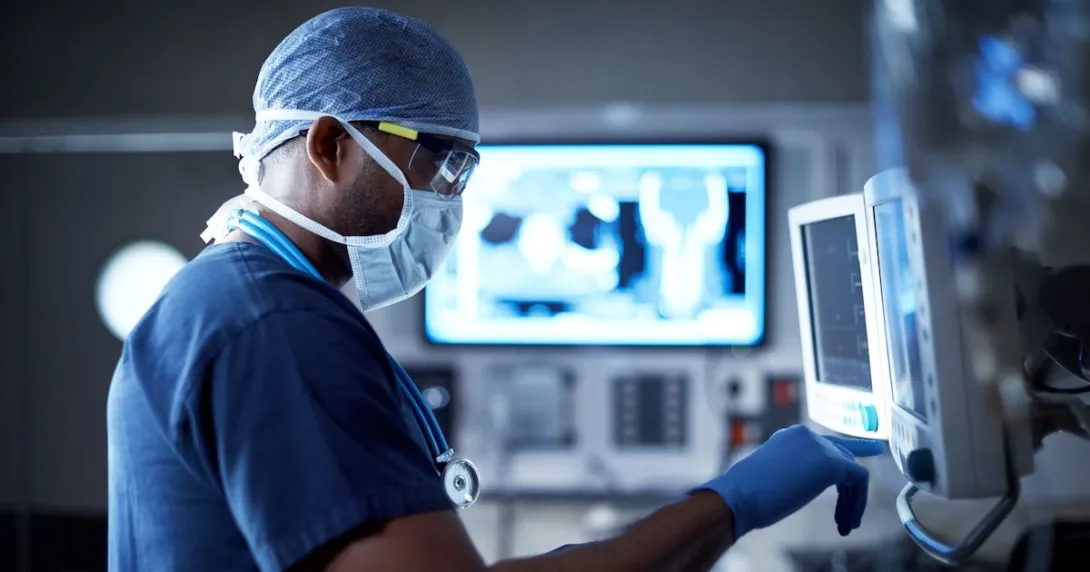 A surgeon looking at a monitor.