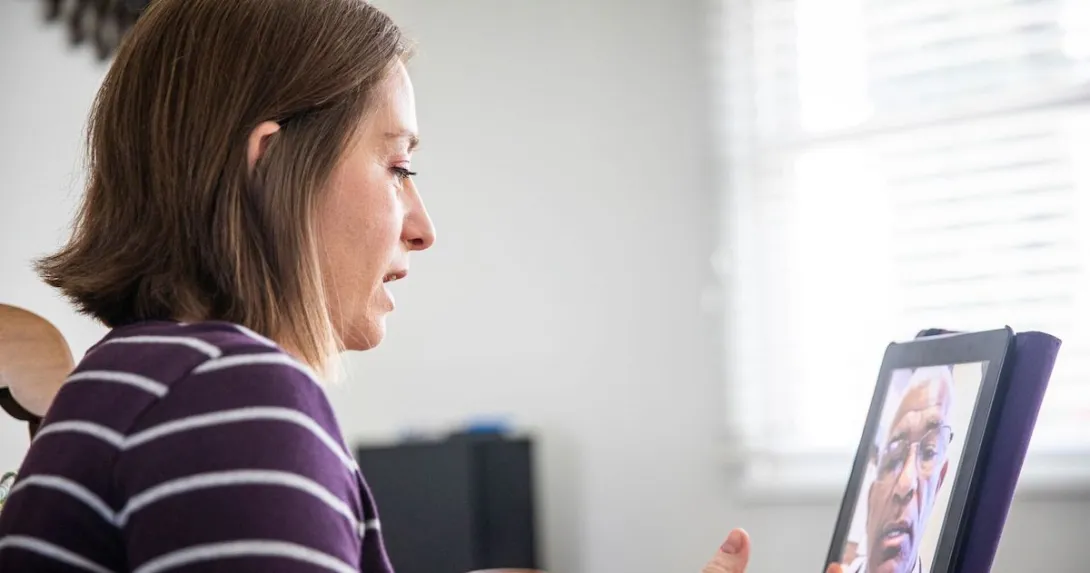 A woman talking to a provider via a video call on her tablet. A woman talking to a provider via a video call on her tablet.