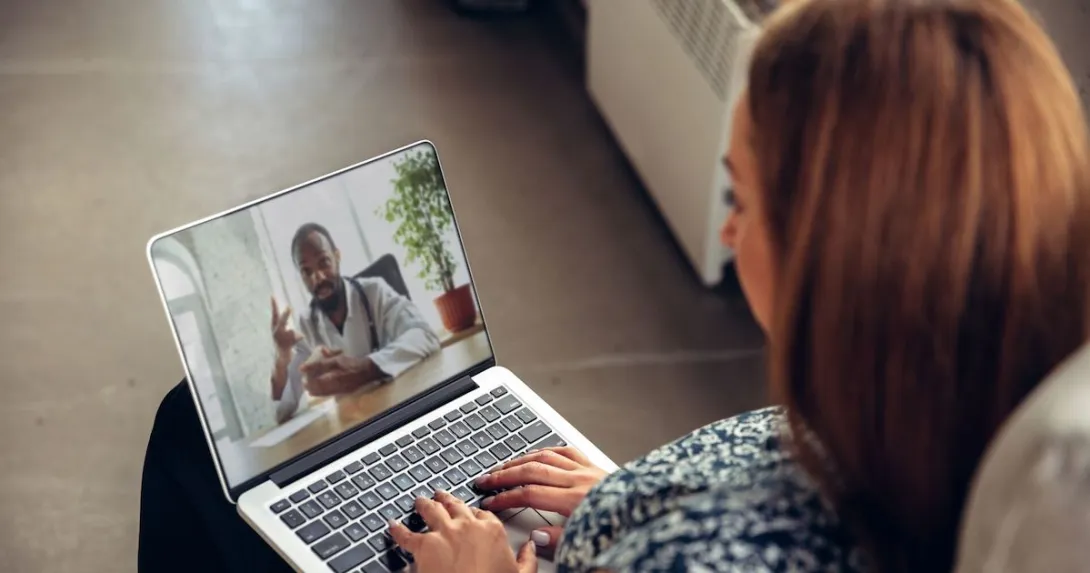 A woman talking to a doctor via telehealth A woman talking to a doctor via telehealth
