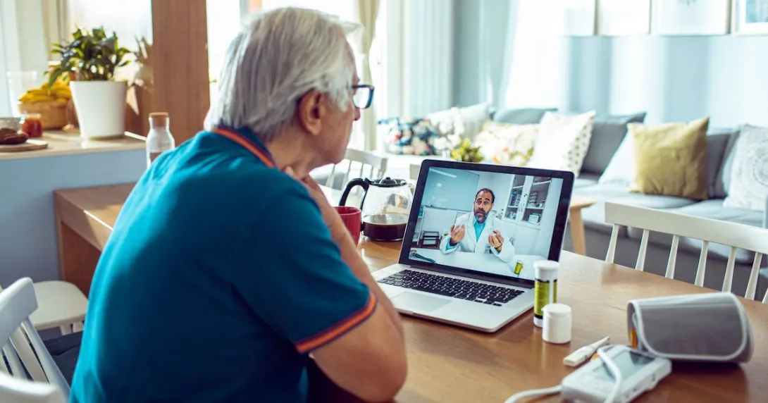 An older man talking to a provider via telehealth An older man talking to a provider via telehealth