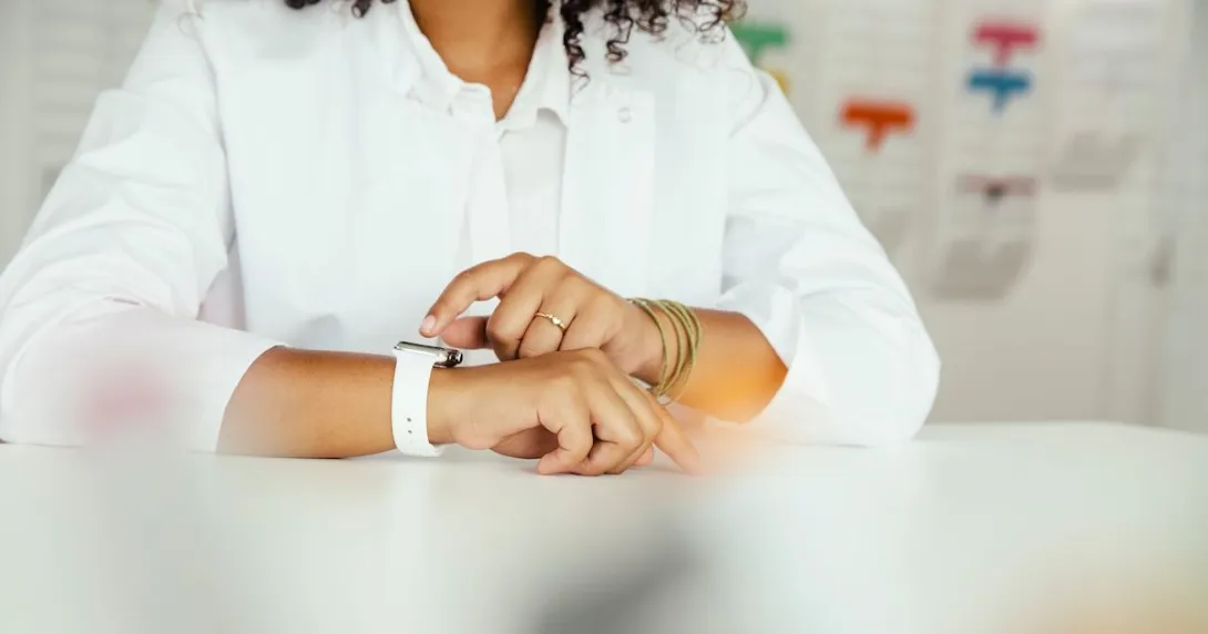 A close-up of a person sitting while wearing a smartwatch A close-up of a person sitting while wearing a smartwatch
