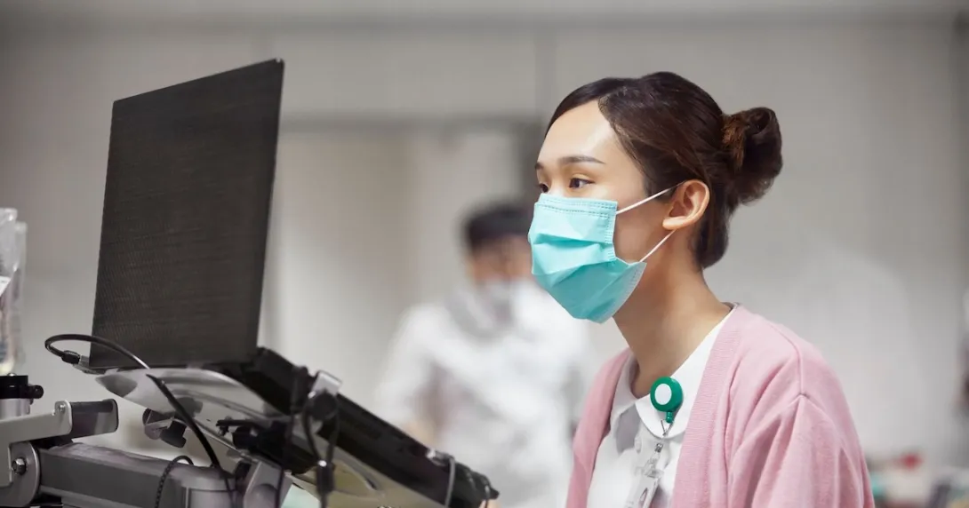 Healthcare professional looking at a computer Healthcare professional looking at a computer