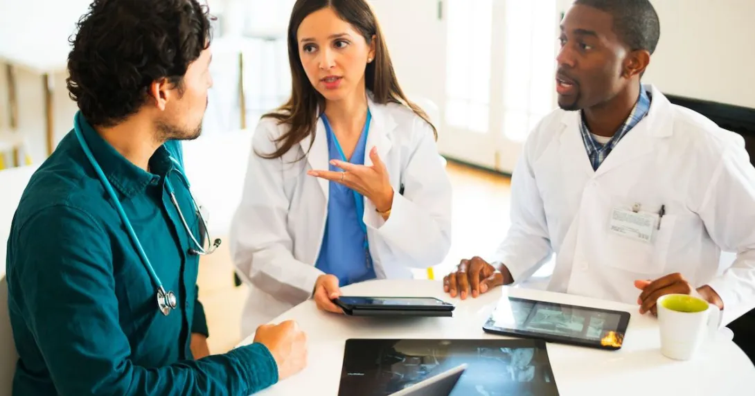 People sitting together looking at devices People sitting together looking at devices