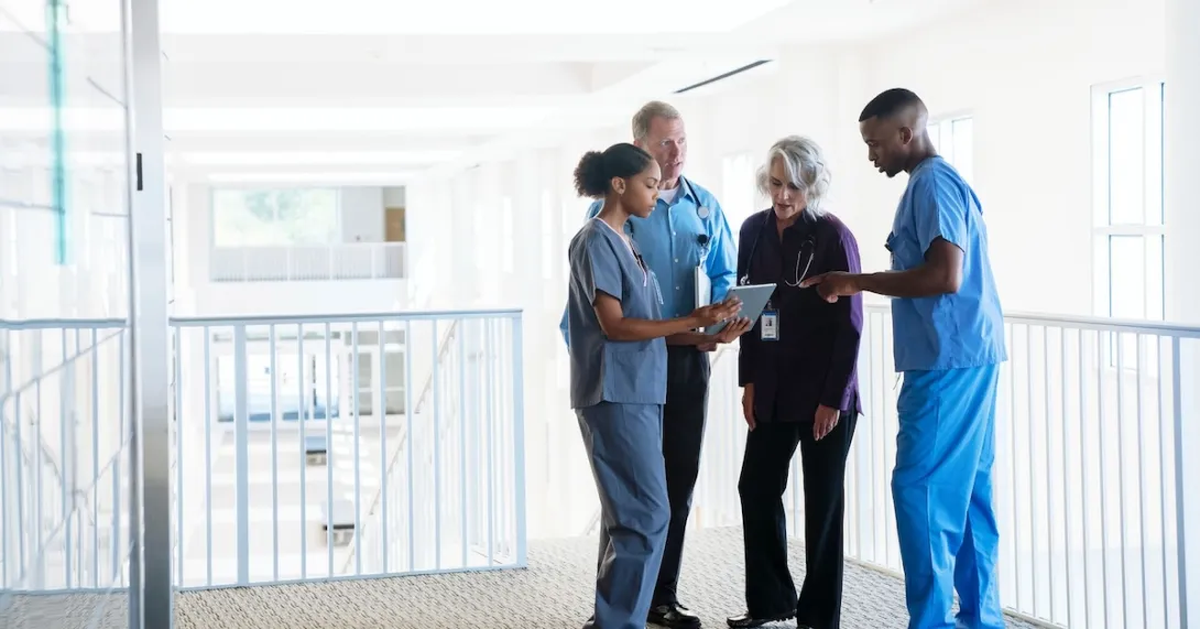Healthcare providers standing in a circle Healthcare providers standing in a circle