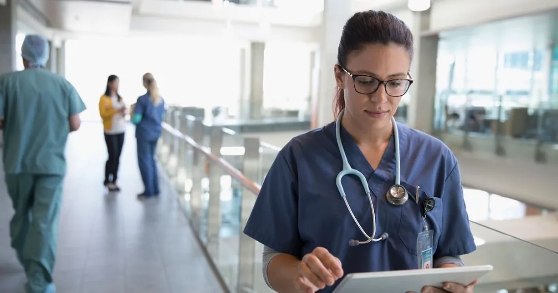 Healthcare provider looking at a tablet Healthcare provider looking at a tablet