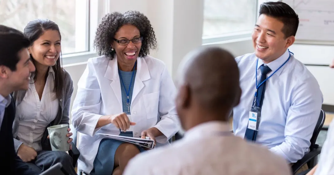 Five people sitting in a circle talking Five people sitting in a circle talking