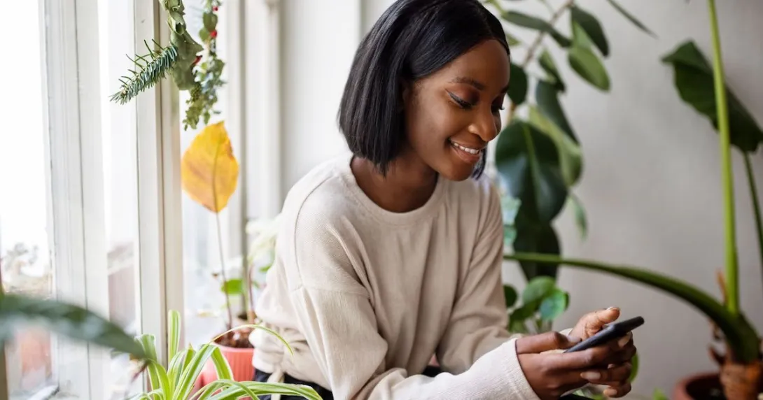 Person sitting in a chair while looking at a phone Person sitting in a chair while looking at a phone