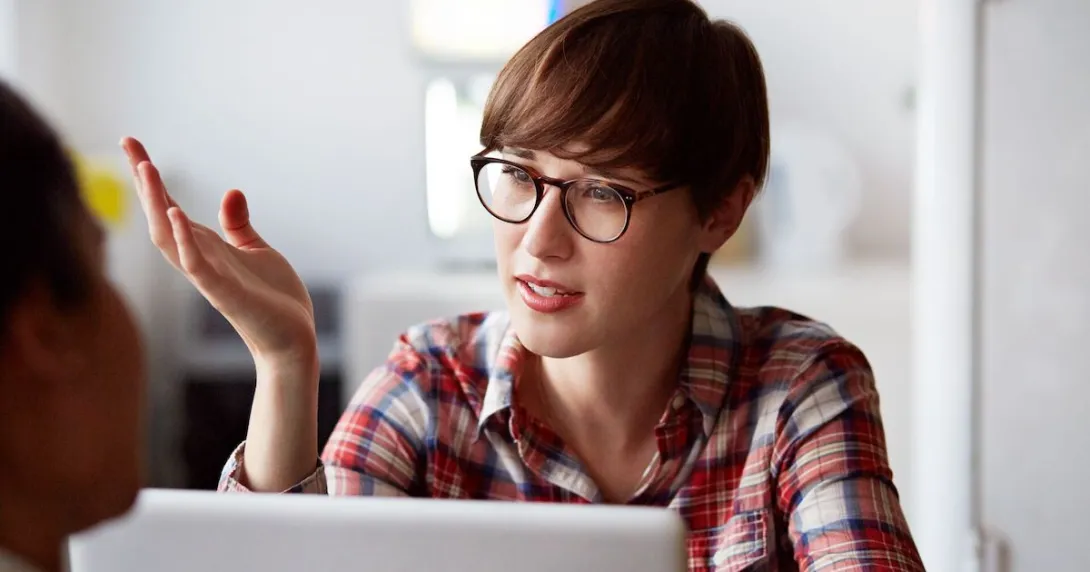 Person wearing glasses and sitting in front of a computer Person wearing glasses and sitting in front of a computer