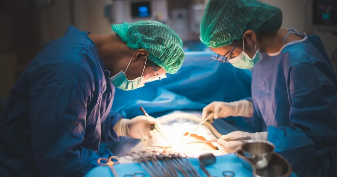 Two surgeons operating on a body Two surgeons operating on a body