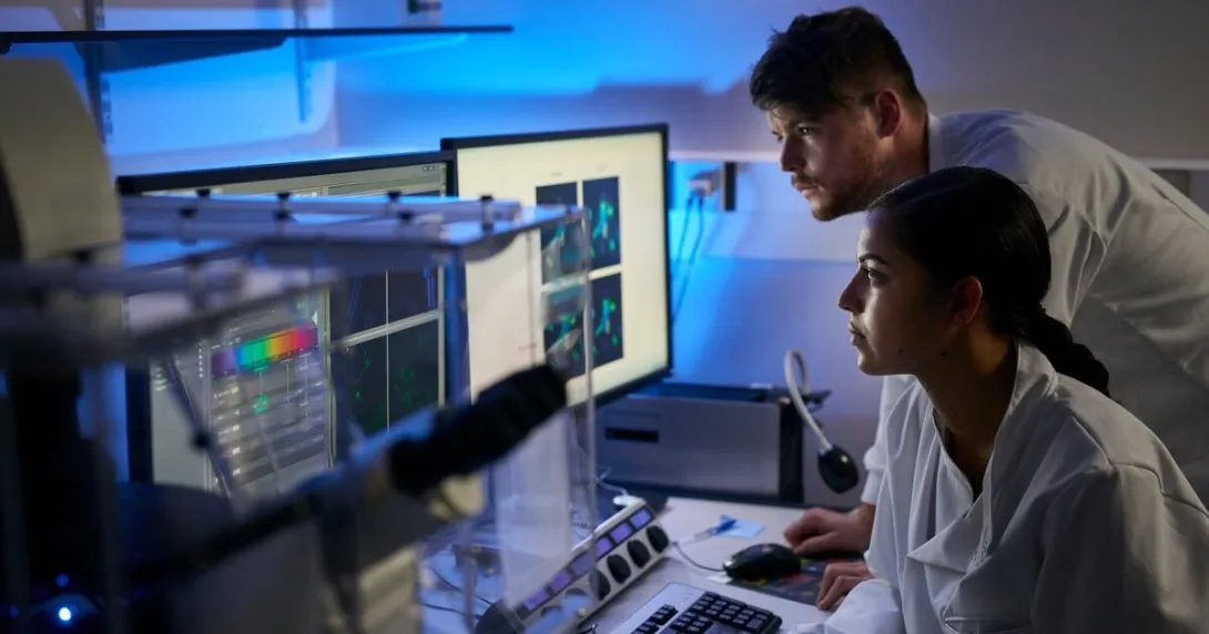 Laboratory scientists reviewing a computer-aided analysis Laboratory scientists reviewing a computer-aided analysis