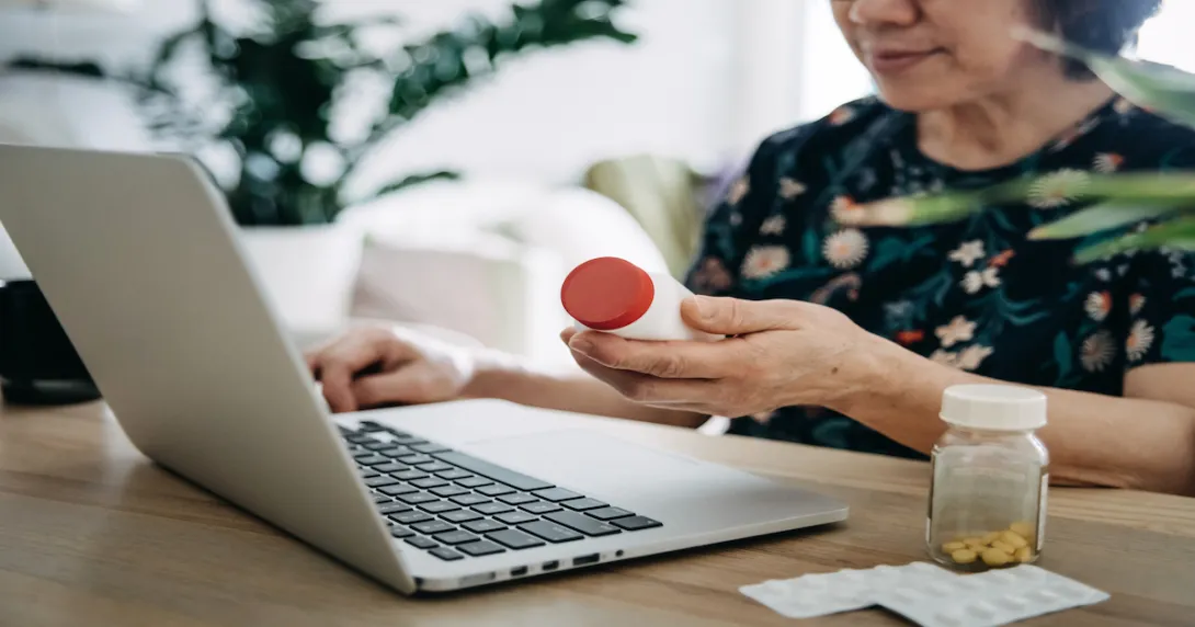 A woman looking up prescription prices online A woman looking up prescription prices online