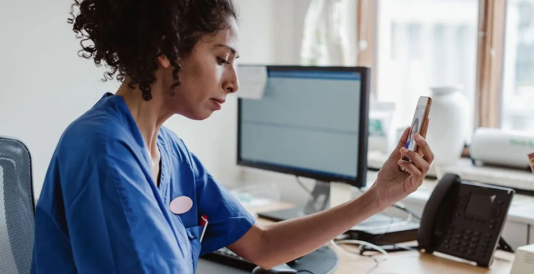 A doctor talking to a patient through a video call on her smartphone A doctor talking to a patient through a video call on her smartphone